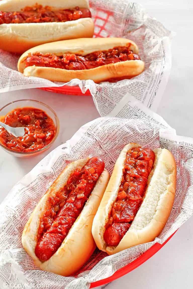 two baskets with baked hot dogs topped with barbecue sauce