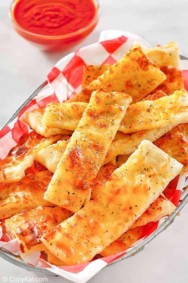 a basket of homemade Little Caesar's Italian cheese breadsticks