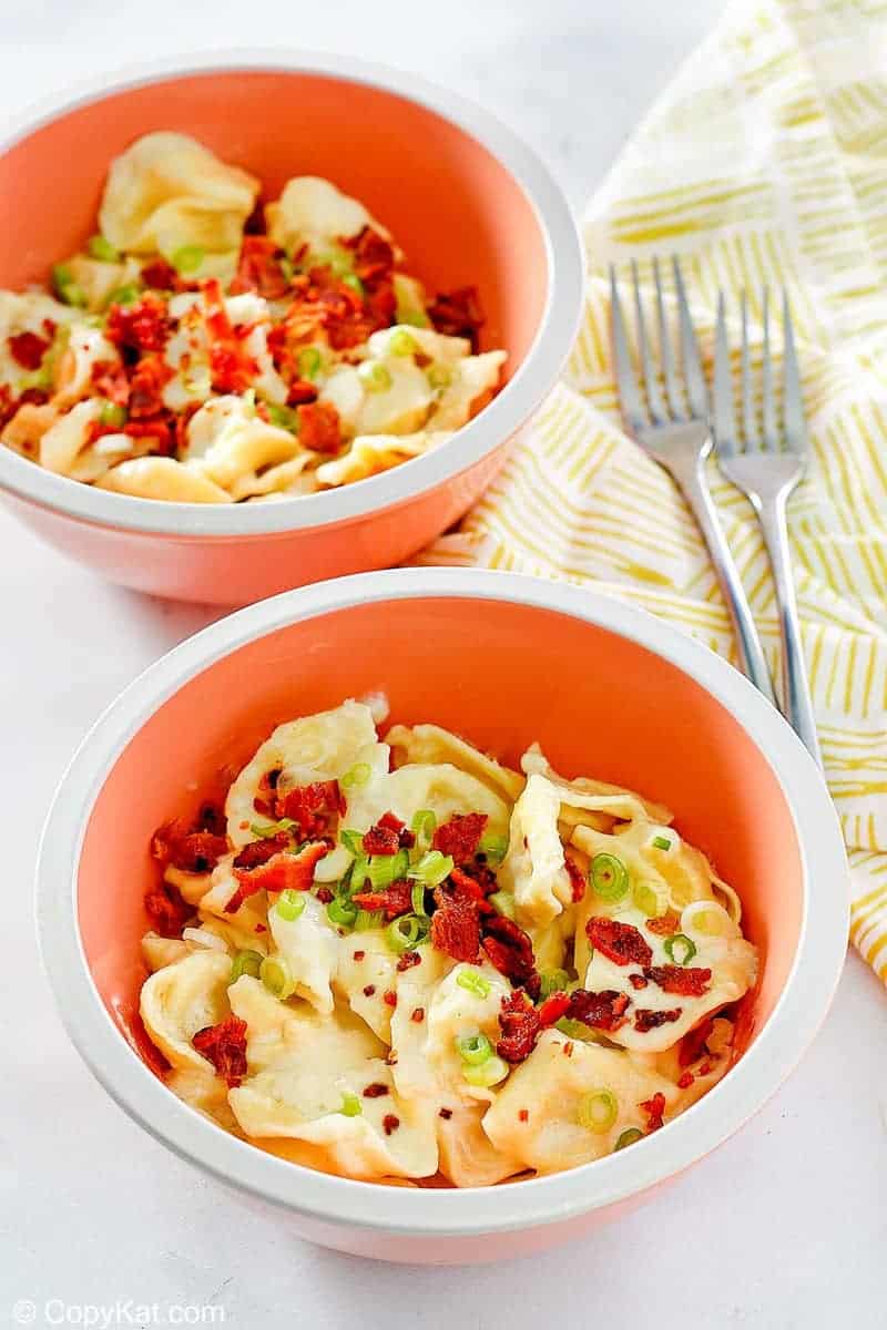 two bowls of homemade Olive Garden tortellini al forno and two forks