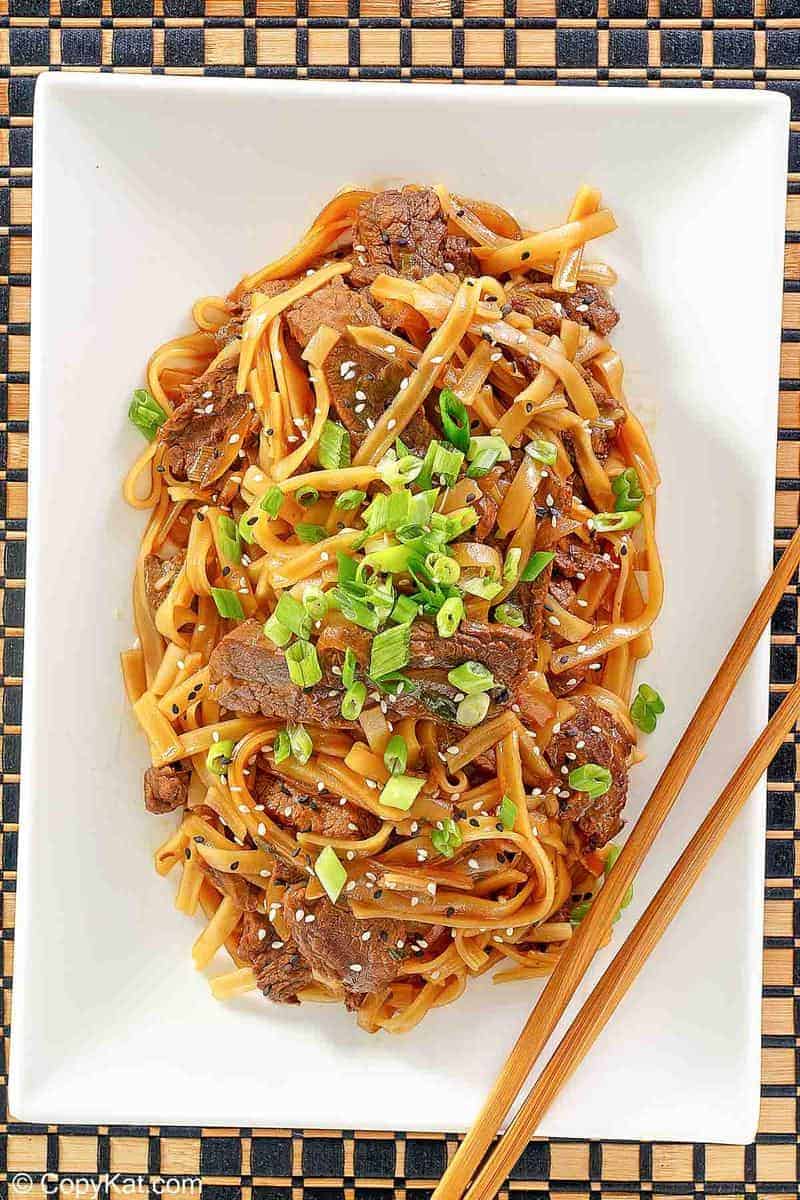 overhead view of beef chow fun on a platter