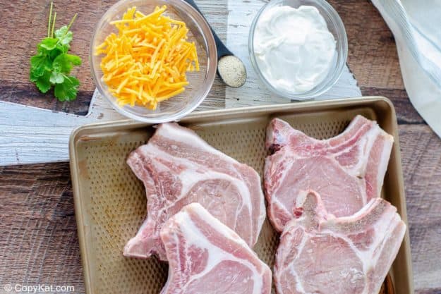 shredded cheese, seasoned salt, sour cream, and pork chops