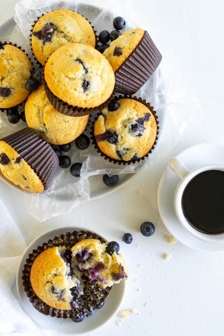 overhead view of blueberry muffins in a basket and on a plate
