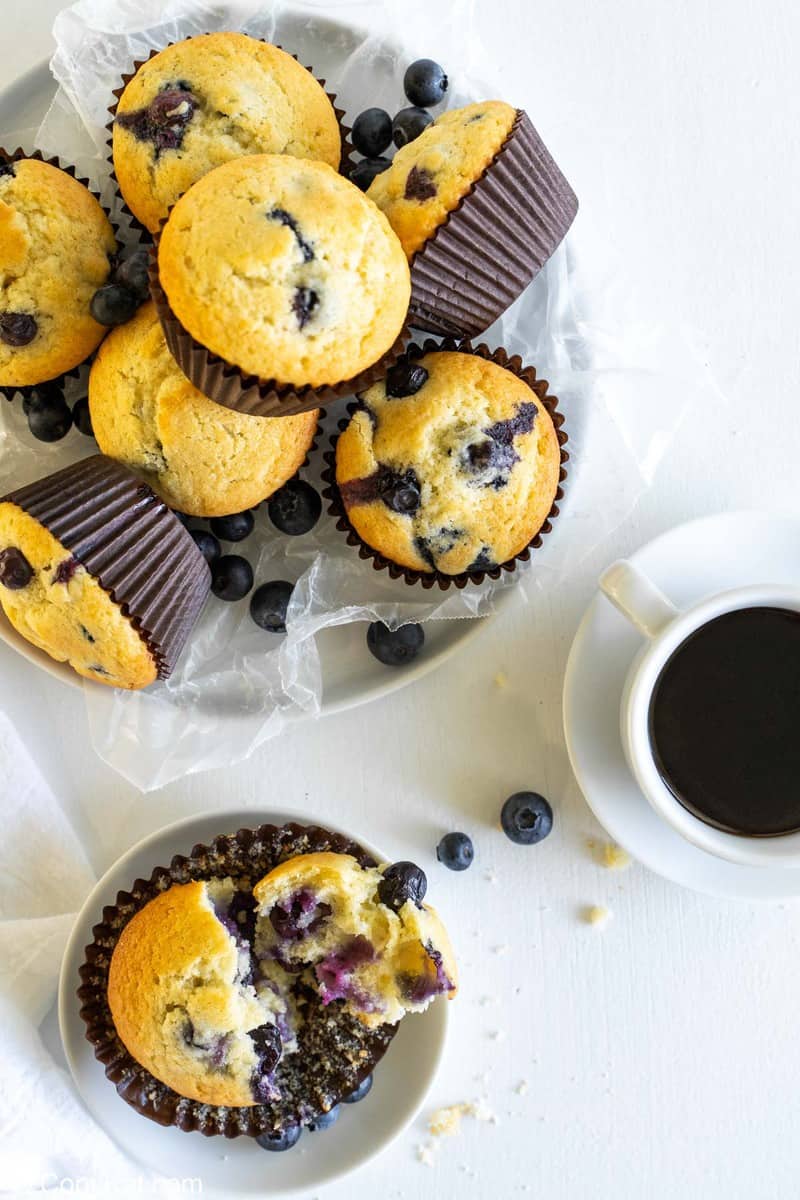 overhead view of blueberry muffins in a basket and on a plate