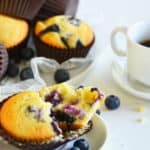 split open blueberry muffin on a plate