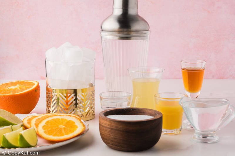 Ingredients for Olive Garden Italian Margarita including tequila, amaretto, citrus, and sugar.