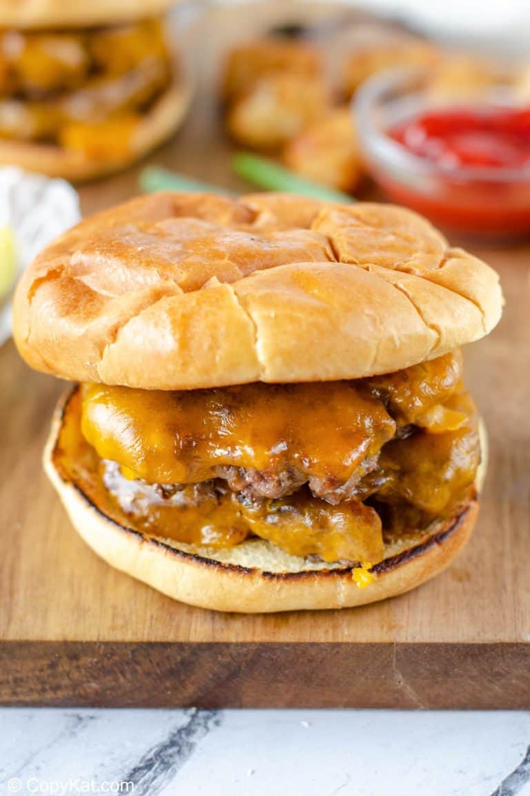 Homemade Steak and Shake garlic double cheeseburger on a wood cutting board.