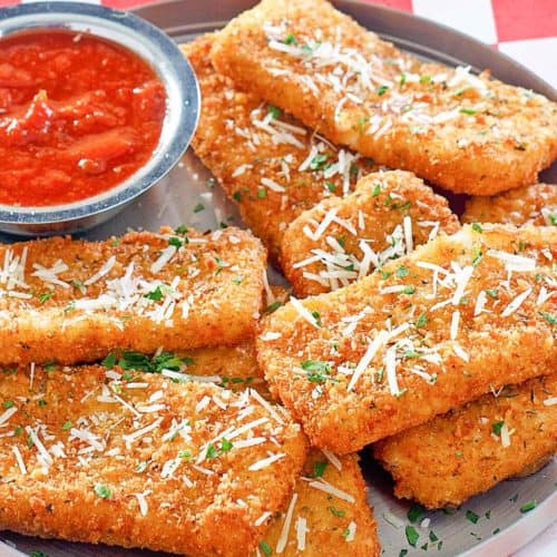 copycat TGI Friday's Fried Mozzarella Sticks and marinara sauce on a platter