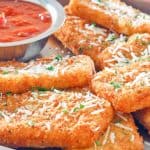 homemade TGI Friday's Fried Mozzarella Sticks and marinara sauce on a platter
