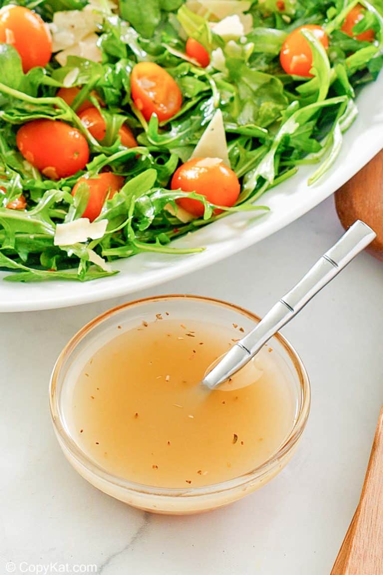 small bowl of homemade Italian dressing and a salad