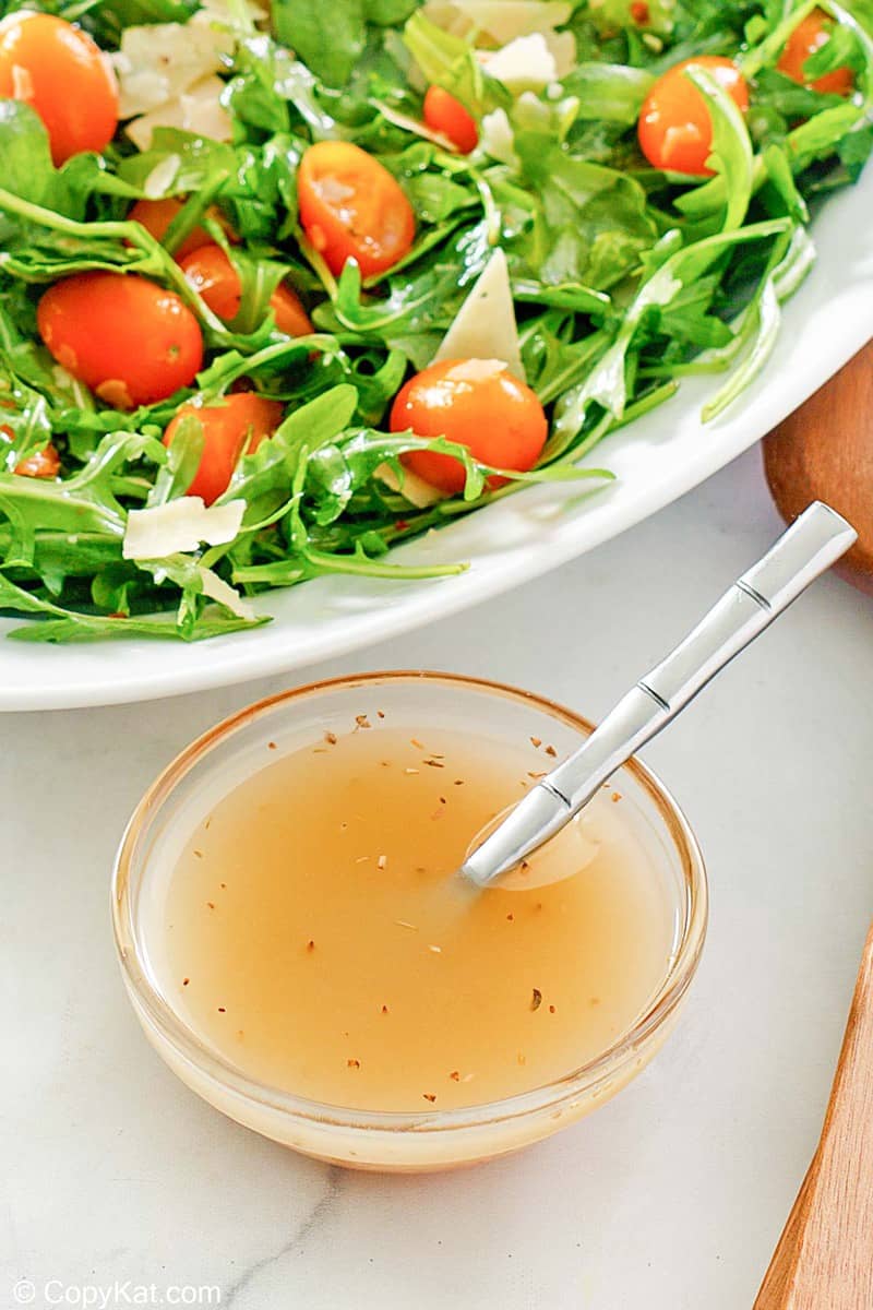 small bowl of homemade Italian dressing and a salad