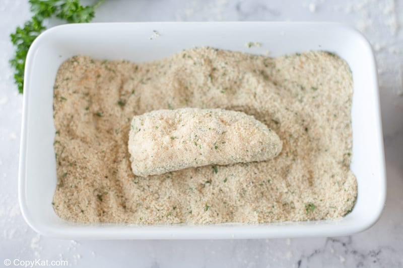coating a cheese stuffed jalapeno pepper in breadcrumbs