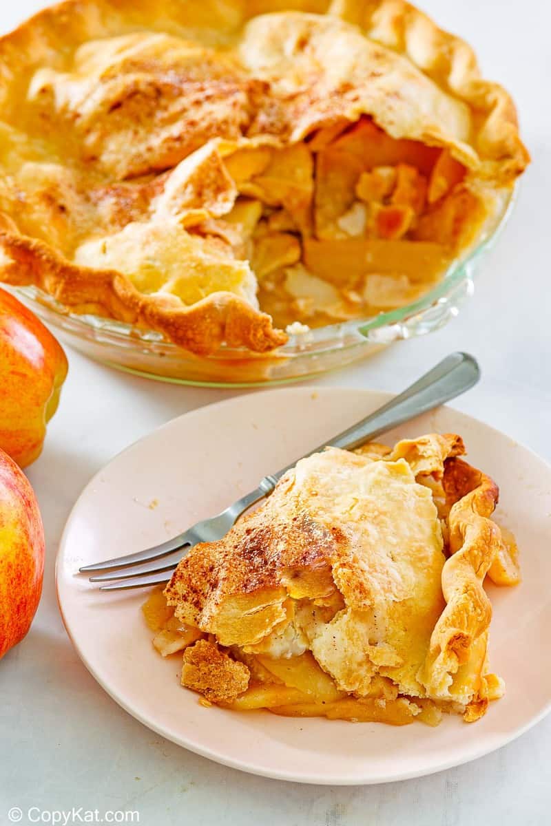 old fashioned apple pie and a slice on a plate