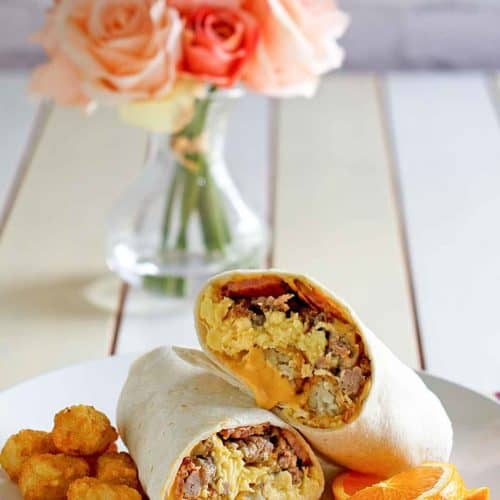 homemade Sonic ultimate meat and cheese breakfast burrito and tater tots on a plate