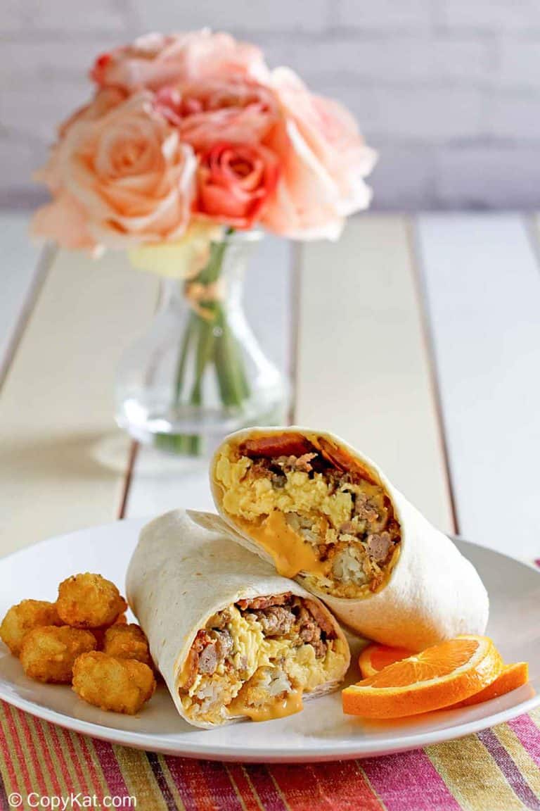 homemade Sonic ultimate meat and cheese breakfast burrito and tater tots on a plate