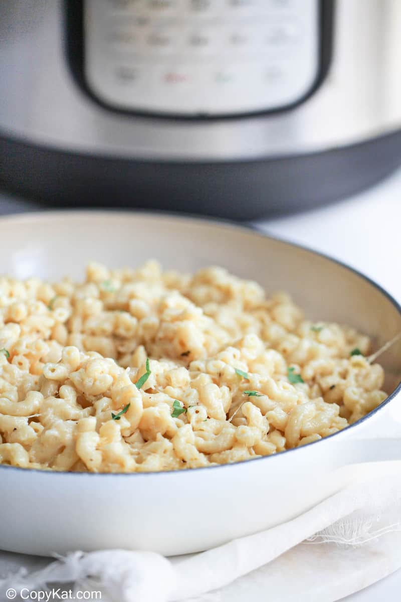 a bowl of white cheddar mac and cheese in front of an Instant Pot