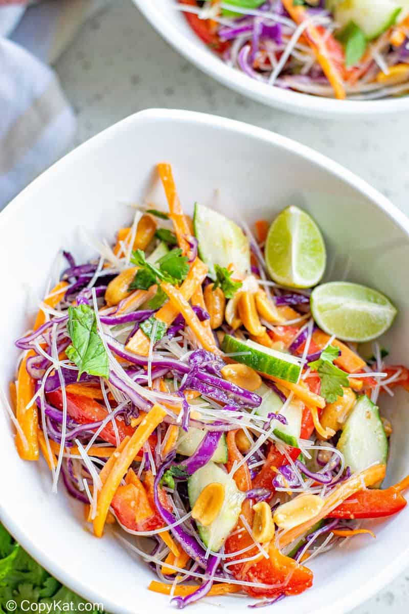 Thai noodle salad and lime wedges in a bowl