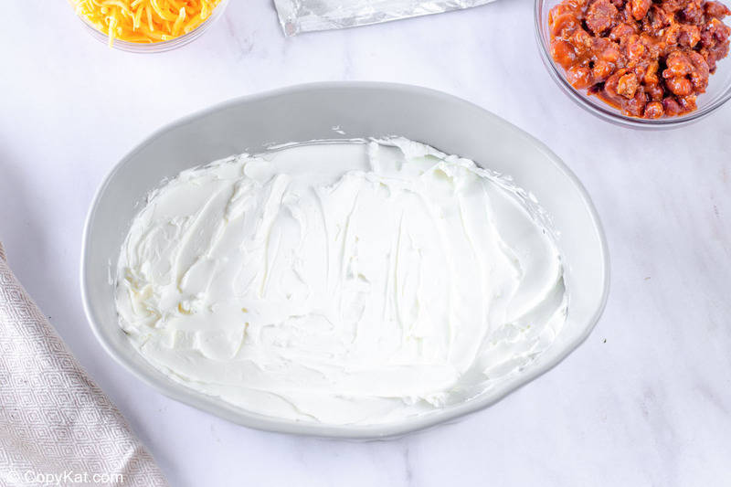 cream cheese spread in the bottom of a baking dish