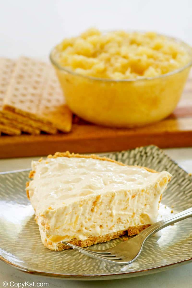 million dollar pie slice, bowl of crushed pineapple, and graham crackers