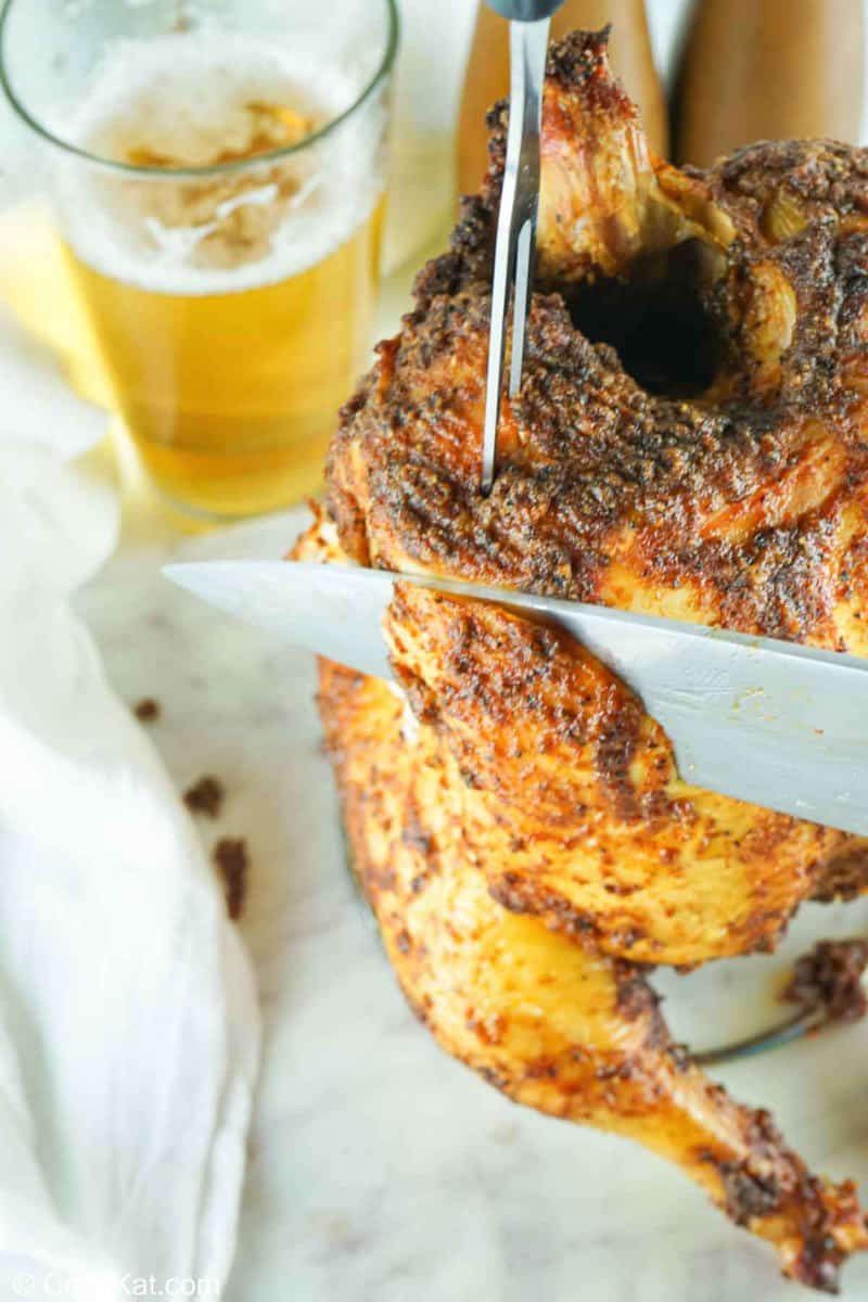 knife cutting into a smoked beer can chicken