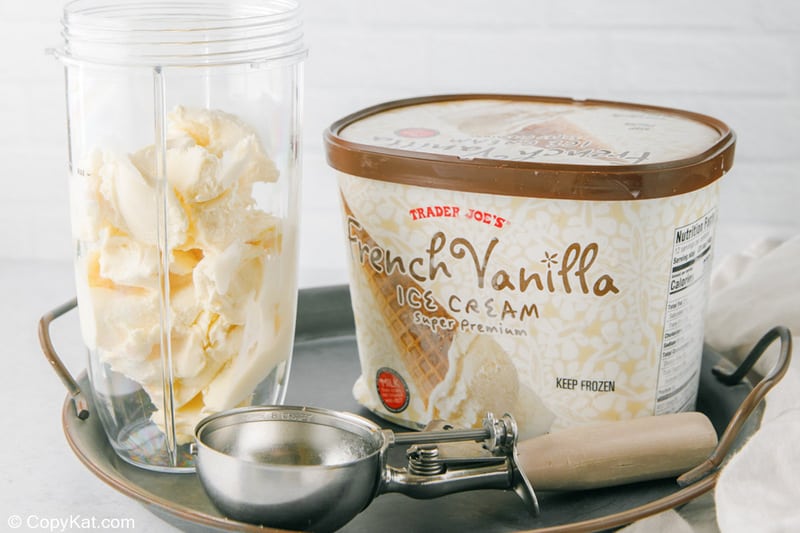 adding ice cream into a blender for a banana milkshake