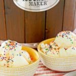 two bowls of homemade vanilla ice cream and an ice cream maker