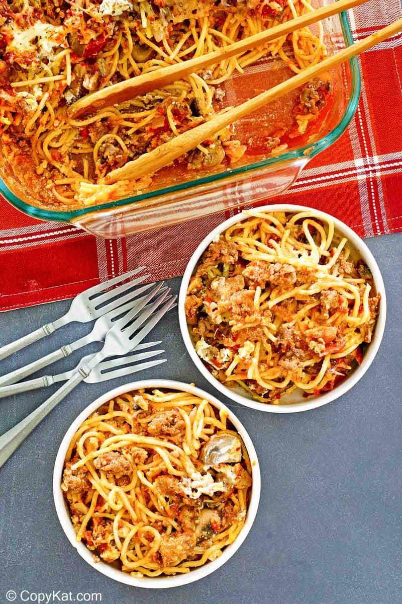spaghetti casserole in a baking dish and two bowls