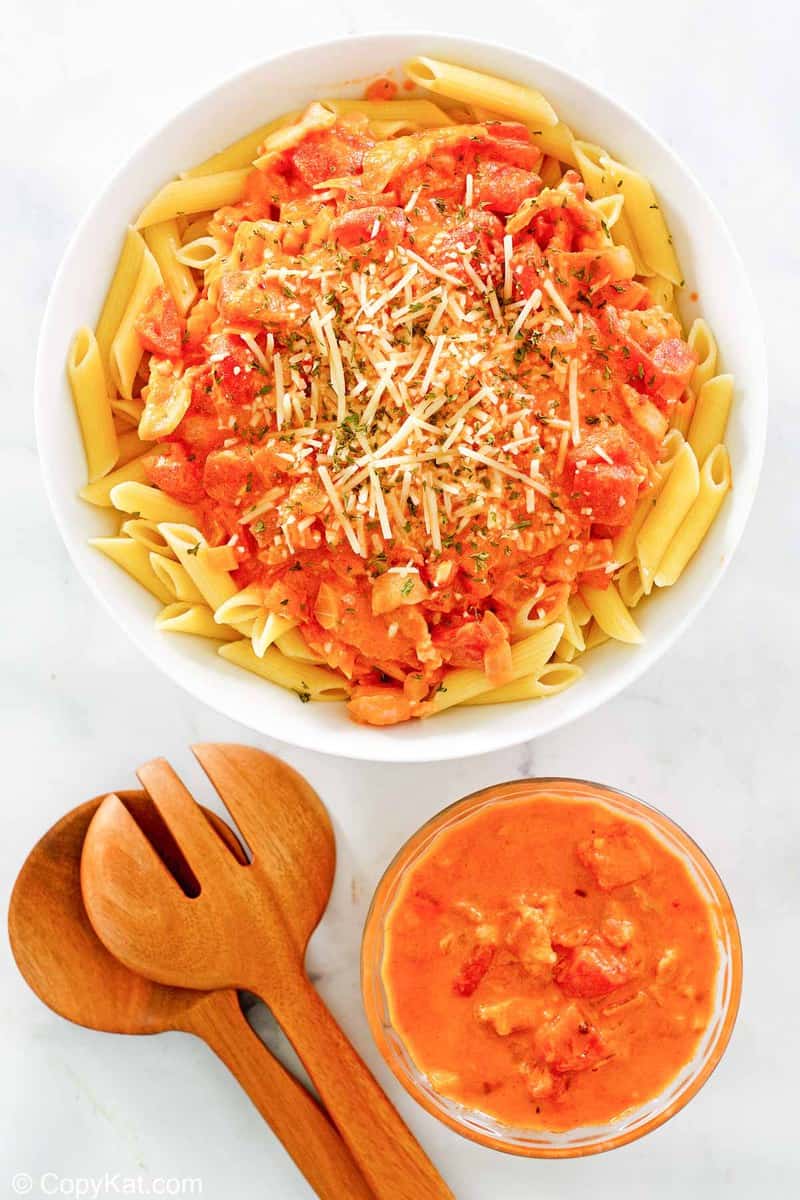 overhead view of penne alla vodka and vodka sauce in bowls.