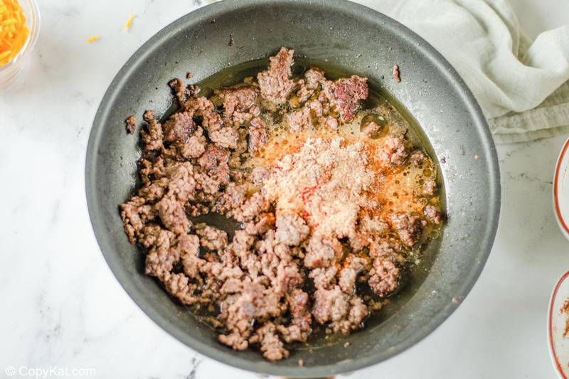 browned ground beef and Taco Bell seasoning mix in a skillet