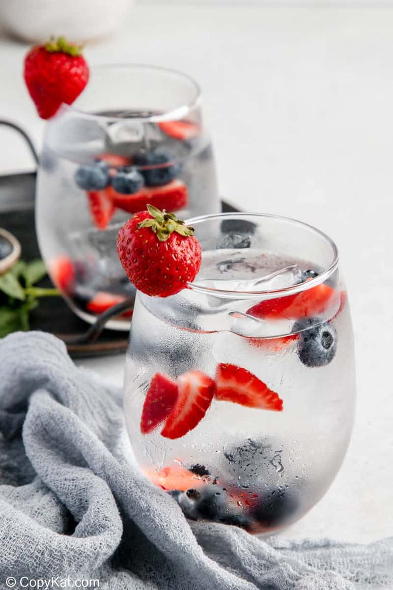 glasses of fruit flavored water with strawberries and blueberries