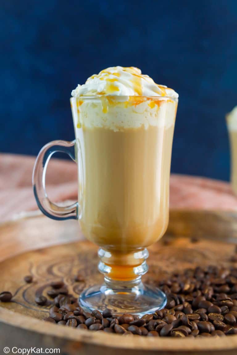 homemade Starbucks caramel macchiato on a wood tray.