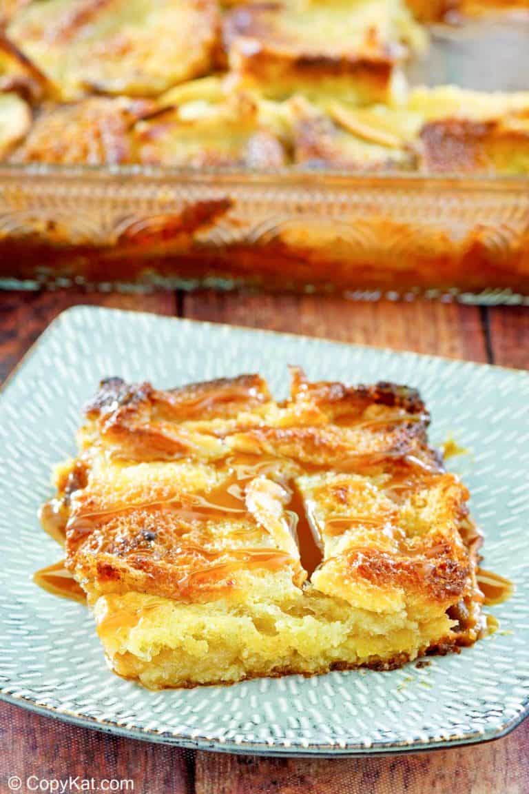 apple bread pudding with caramel sauce on a plate.
