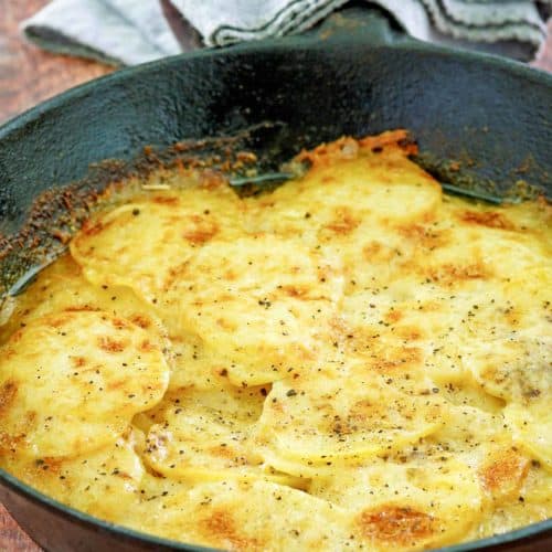 cheesy potatoes au gratin in a skillet.