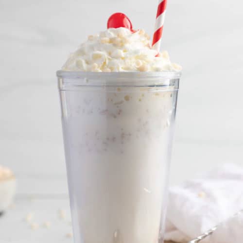 homemade Jack in the Box Rice Krispie Shake topped with whipped cream, a cherry, and cereal.