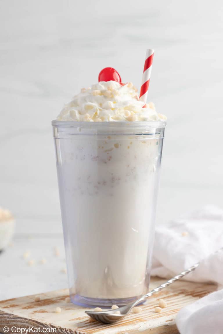 homemade Jack in the Box Rice Krispie Shake topped with whipped cream, a cherry, and cereal.