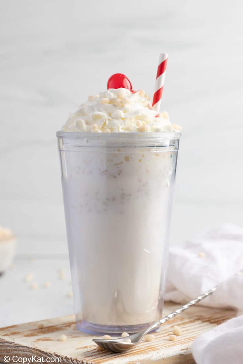 homemade Jack in the Box Rice Krispie Shake topped with whipped cream, a cherry, and cereal.