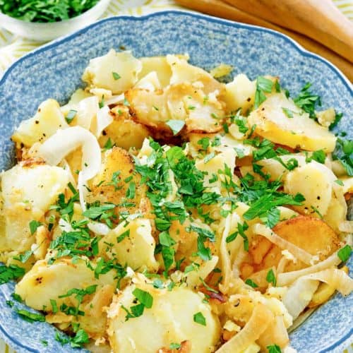 lyonnaise potatoes in a blue serving bowl.