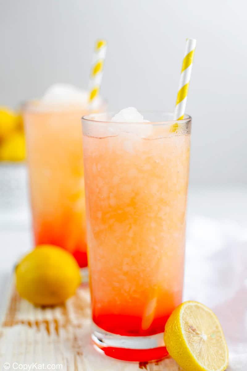 homemade McDonald's frozen strawberry lemonade in glasses with straws.