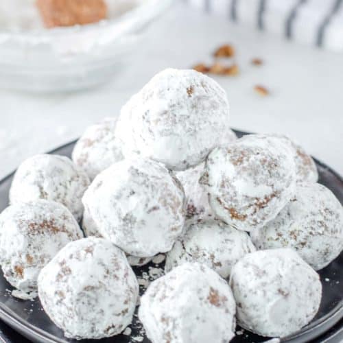 a stack of rum balls on a plate.
