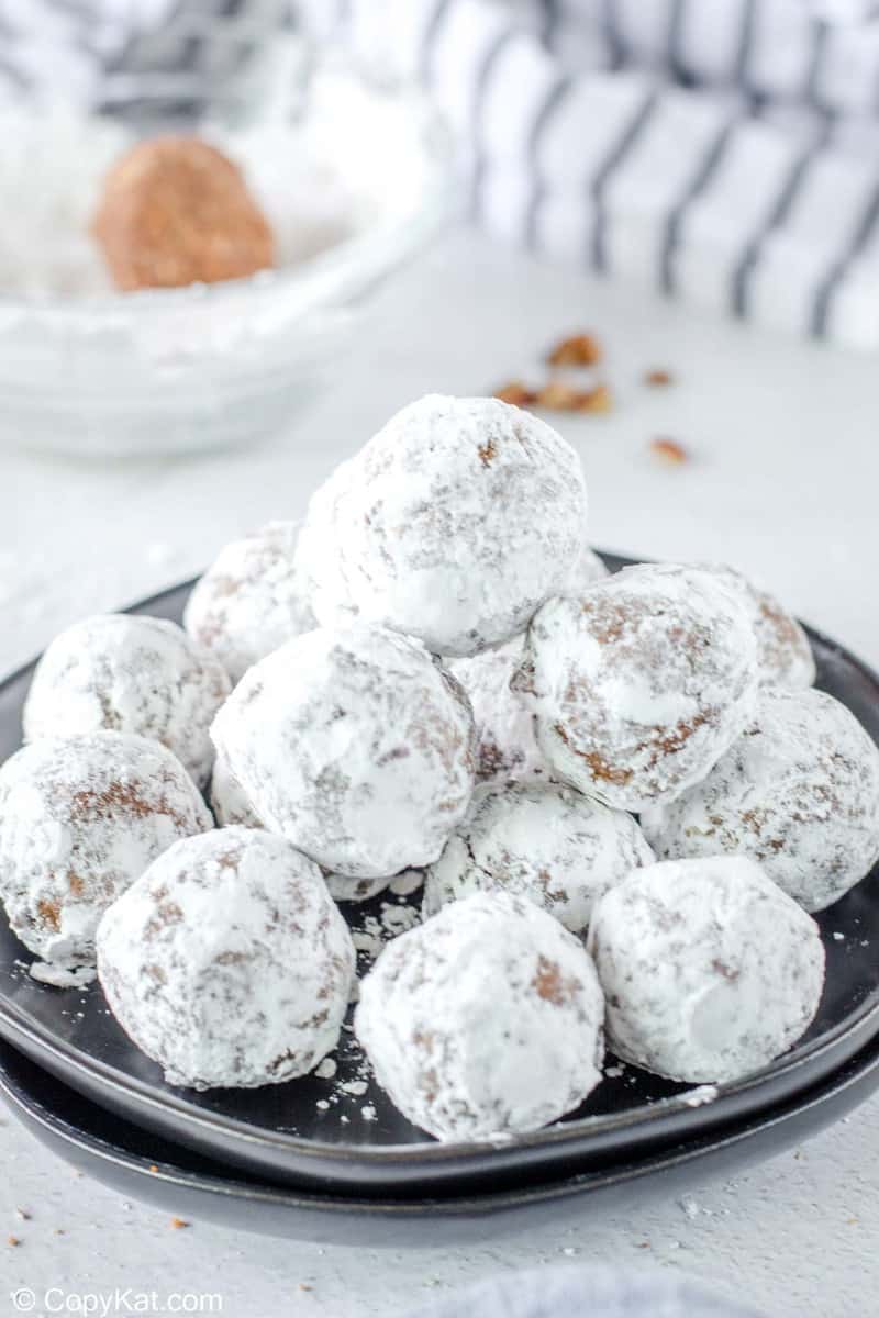 a stack of rum balls on a plate.