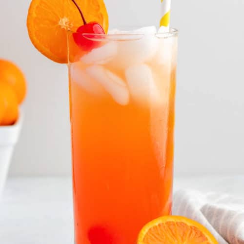homemade Olive Garden Venetian Sunset drink garnished with a cherry and orange slice.