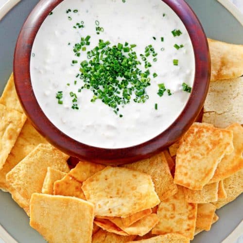 overhead view of clam dip and crackers on a platter.