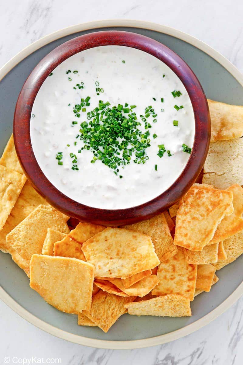 overhead view of clam dip and crackers on a platter.