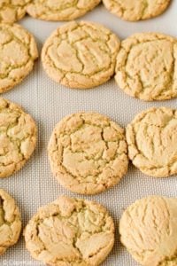 freshly baked gingersnap cookies on a baking sheet.