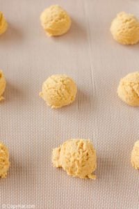 ginger snap cookie dough balls on a baking sheet.