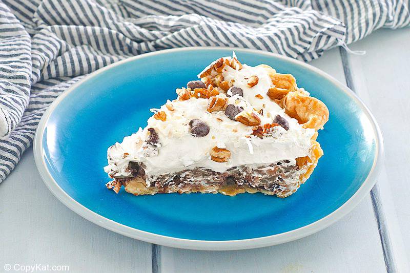 homemade Marie Callender's German Chocolate Pie slice on a blue plate.