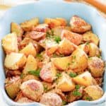 parmesan potatoes in a blue serving dish.