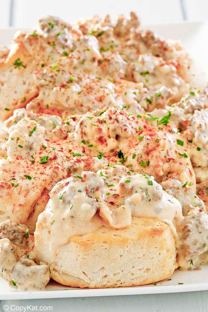 homemade Bob Evans Sausage gravy over biscuits on a platter.