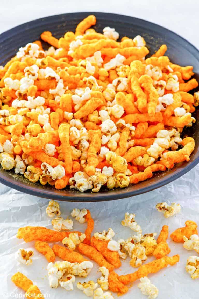 homemade Cheetos popcorn in a big black bowl.