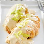 cream cheese chicken topped with green onions on a platter.