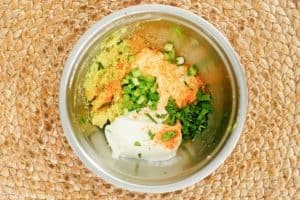 green goddess dip ingredients in a mixing bowl.